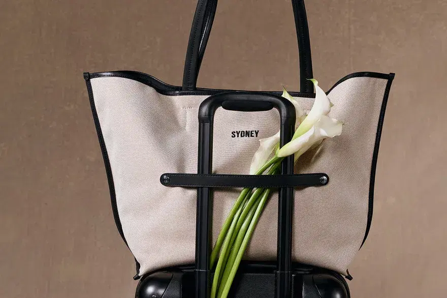 A BÉIS tote styled with a tennis racket and cap.